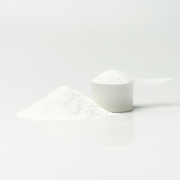 A powder cup of Pure Rebuild, a pineapple flavored muscle recovery supplement